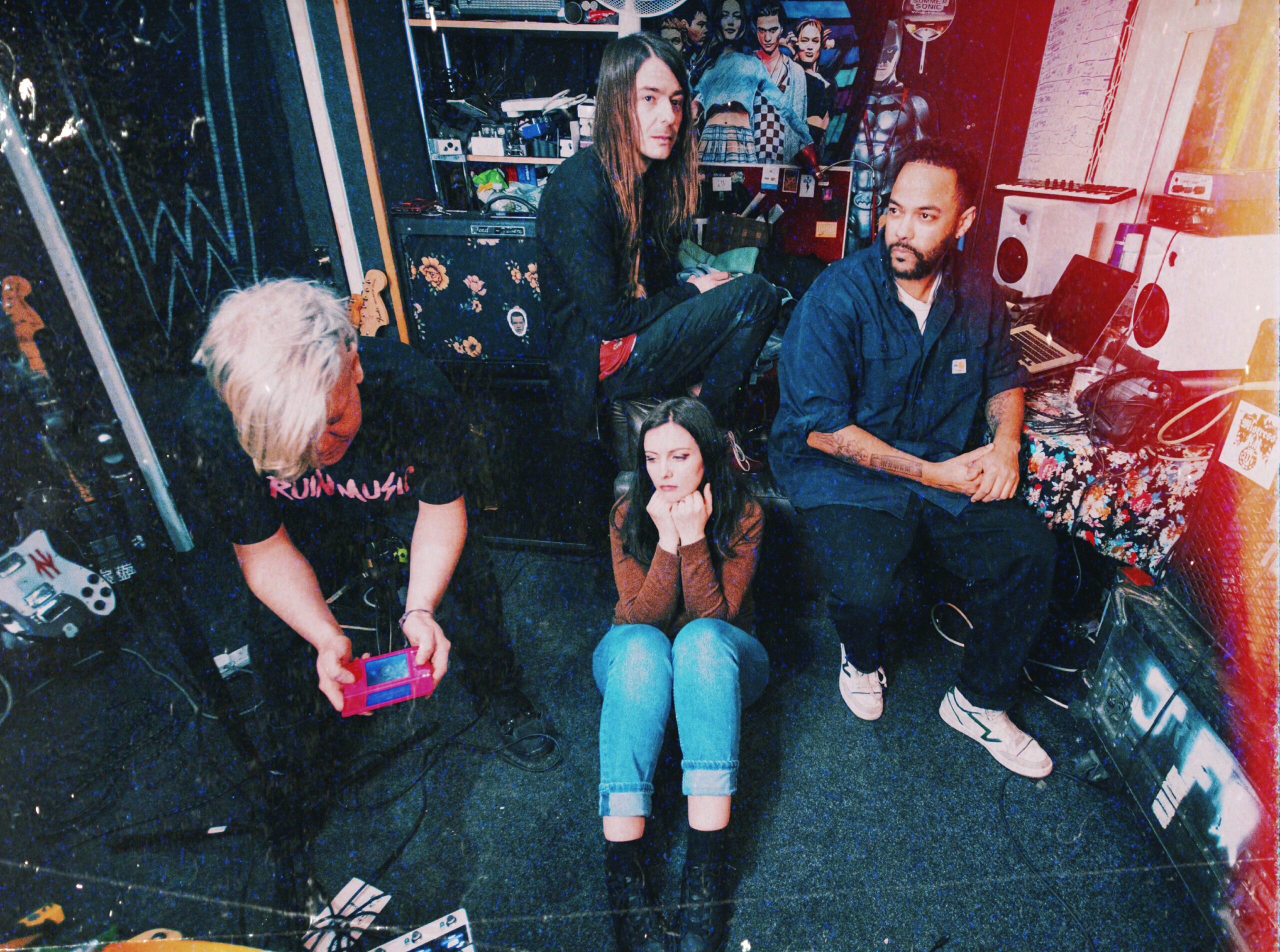 The band Johnny Foreigner, sitting backstage